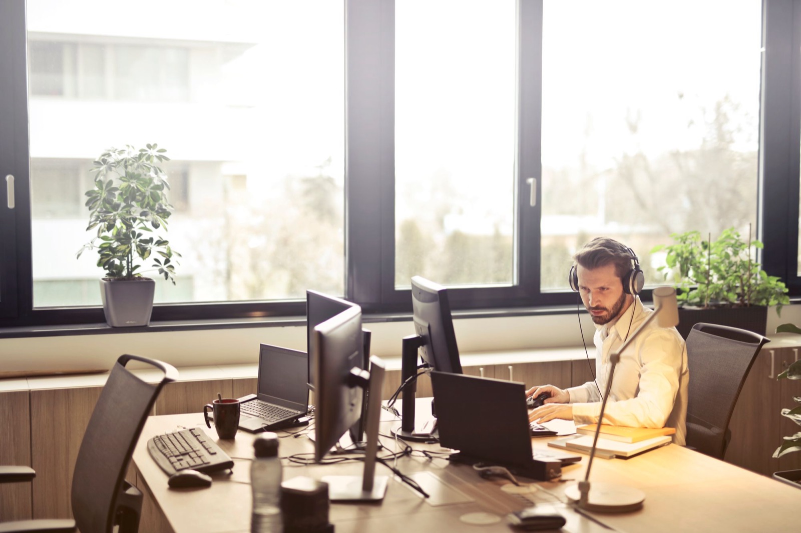 Freight broker at a desk with several monitors